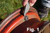 Get the rusty wheel ready for sanding and painting by using a utility knife to cut off the valve stem